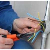 Cutting wires, yellow/green, brown, blue AS Electrics is an electrical contracting company based in Lisburn, Co Antrim