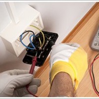 Fixing a wall plug, White and yellow gloves AS Electrics is an electrical electrician contracting in Lisburn, Co Antrim